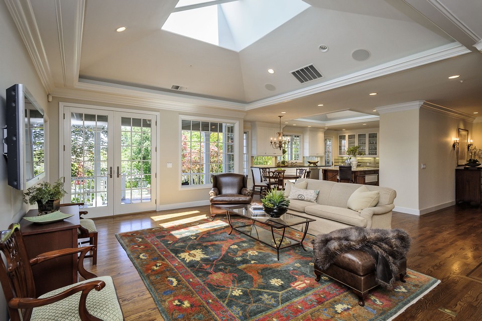 spacious family room adjoining kitchen with french doors to outdoor slate deck and bay views