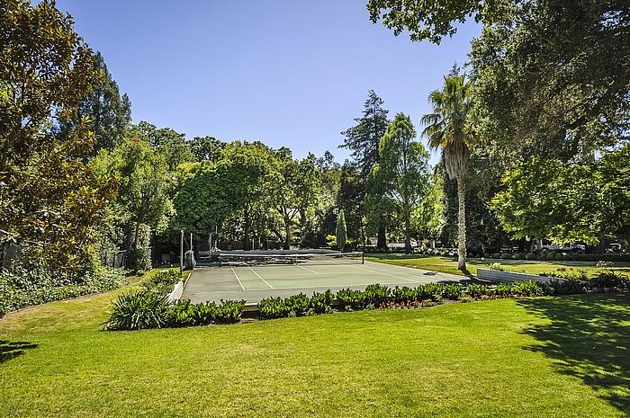 enchanting gardens, lush level lawn and tennis court