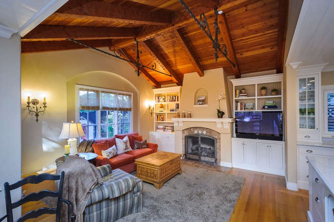 adjacent family room with soaring ceilings, fireplace and breakfast nook