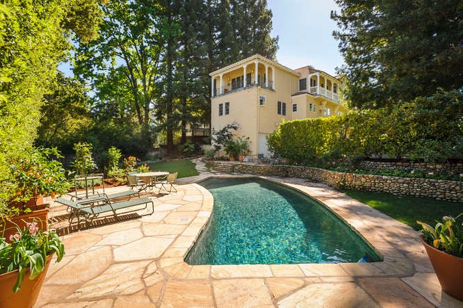 private and lush gardens with mature trees, sparkling pool, patios and koi pond