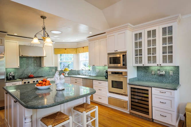 kitchen boasts granite countertops, custom cabinetry and top-of-the-line appliances