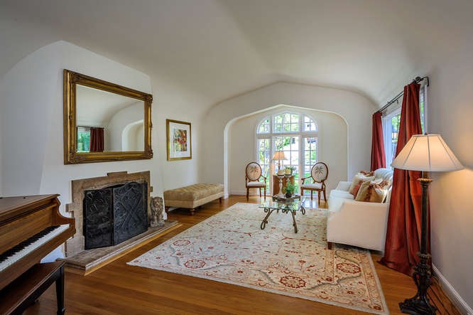 elegant, expansive living room with original fireplace