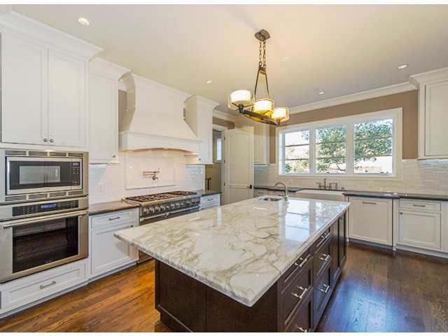 expansive gourmet kitchen with top of the line appliances opens to large family room