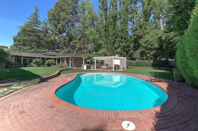 beautiful level yard with large pool and grassy play space