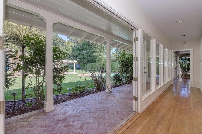 floor-to-ceiling windows and french doors throughout home opening to beautiful yard