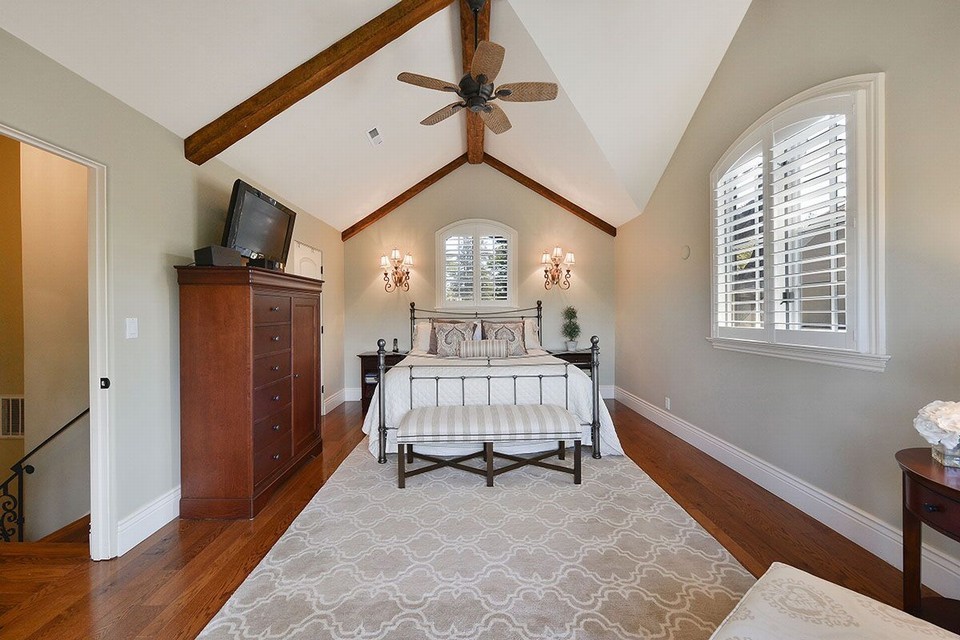 elegant upstairs master bedroom suite features walk-in closet, spa-inspired master bath, and private balcony