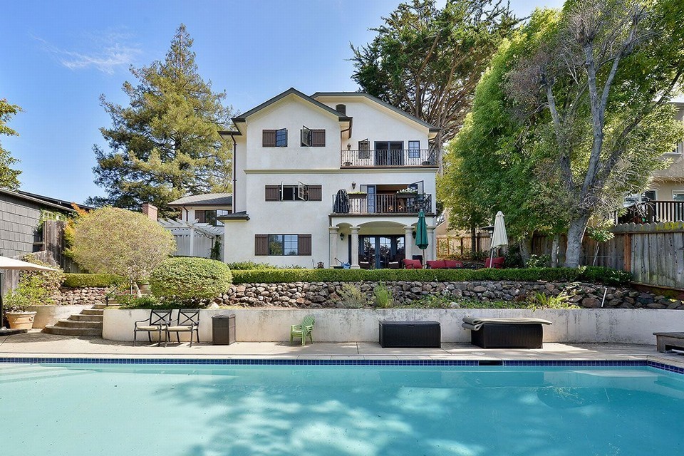 spacious oversized lot includes sparkling pool, grassy play space, outdoor entertaining area