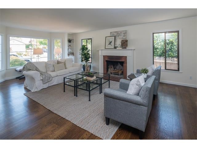 living room has fireplace, large bay window and built-in bookcase