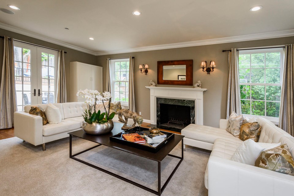 elegantly appointed living room with french doors to outdoor entertaining area