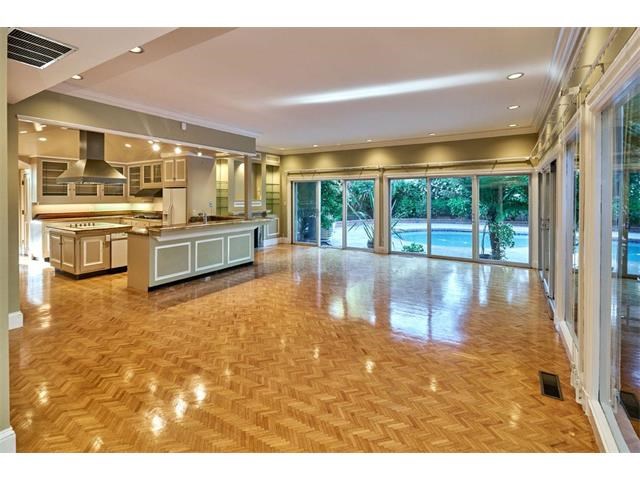 kitchen opens to large family room with views of pool and pool house