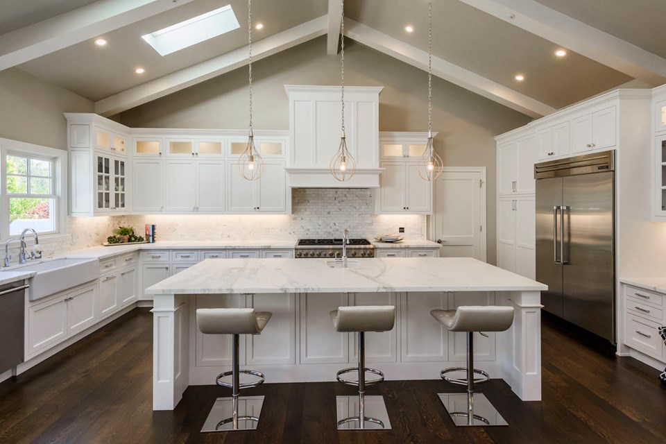 expansive kitchen with calacatta countertops and top-of-the-line appliances